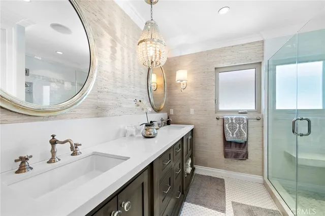 a bathroom with a double vanity sink mirror and shower