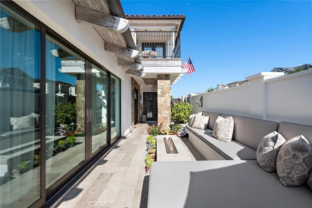 a view of a patio with table and chairs potted plants with floor to ceiling window