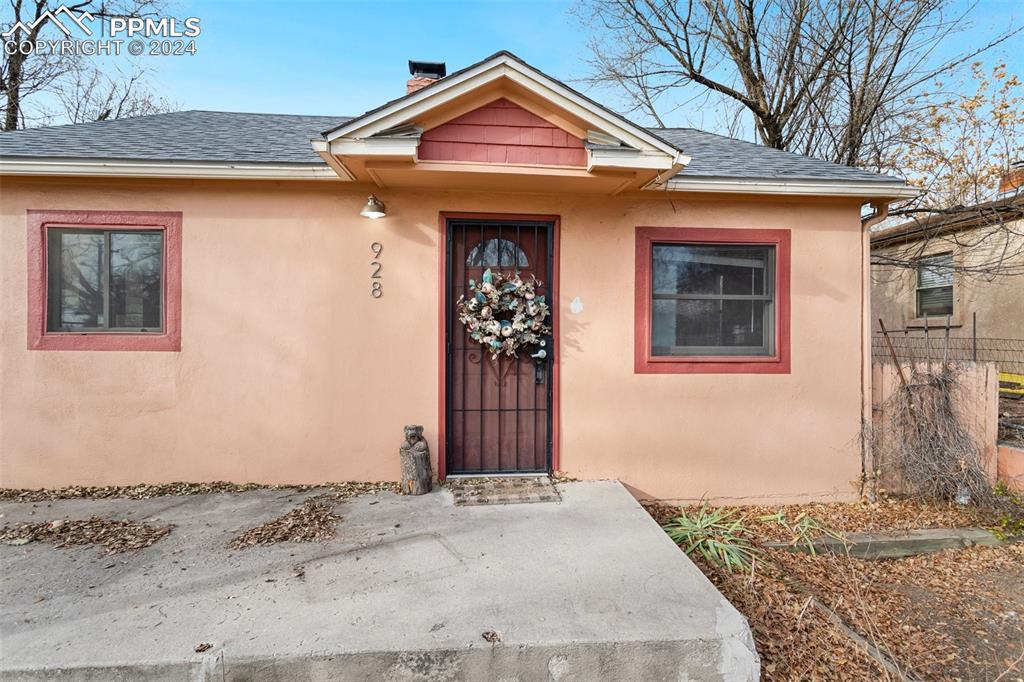 928 Alexander Road Colorado Springs, CO 80909 - Photo 1 of 24 a front view of a house