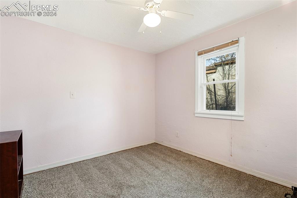 928 Alexander Road Colorado Springs, CO 80909 - Photo 17 of 24 an empty room with a window