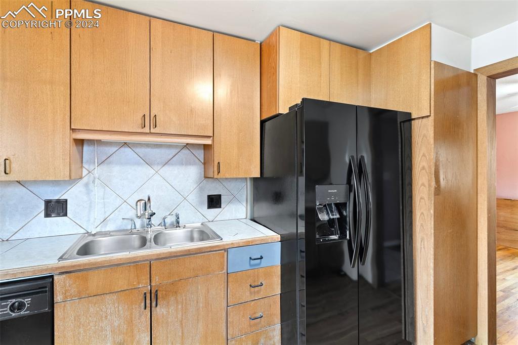 928 Alexander Road Colorado Springs, CO 80909 - Photo 6 of 24 a kitchen with stainless steel appliances granite countertop a refrigerator and a sink