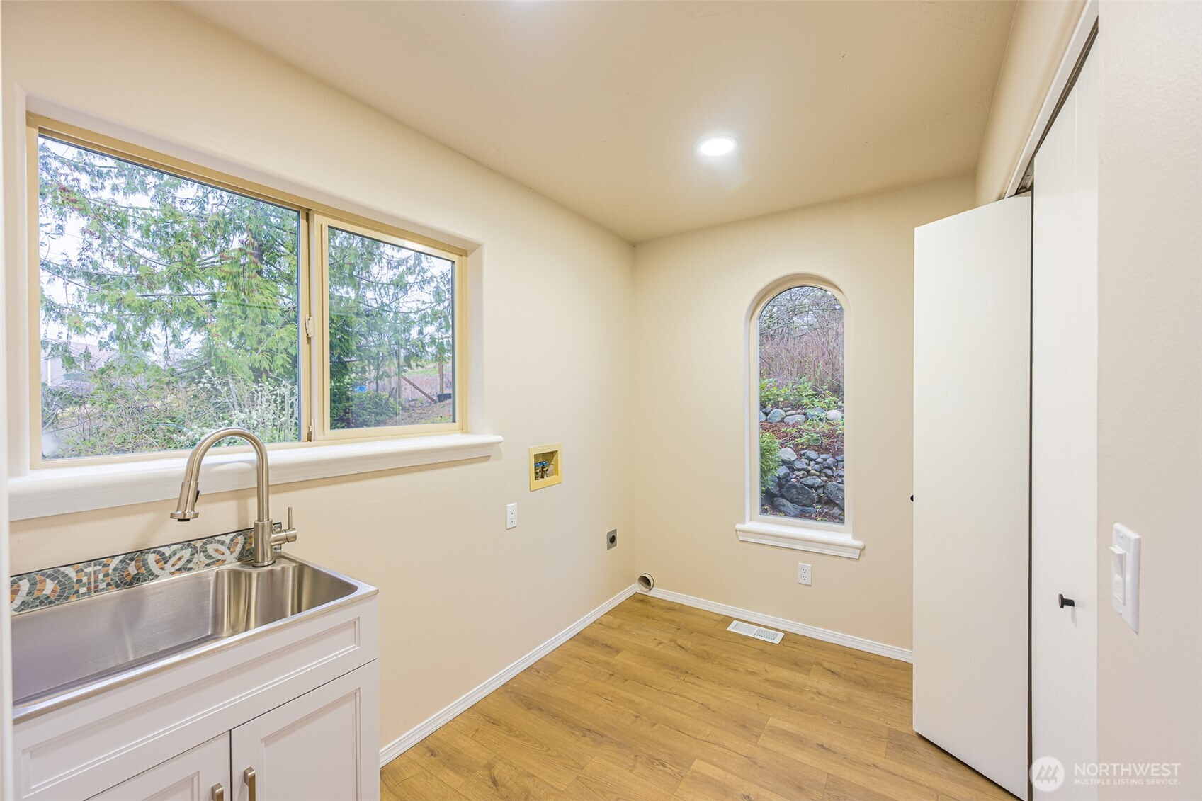 315 Quails Roost Road Sequim, WA 98382 - Photo 17 of 34 a view of a room that has a sink and dishwasher with wooden floor