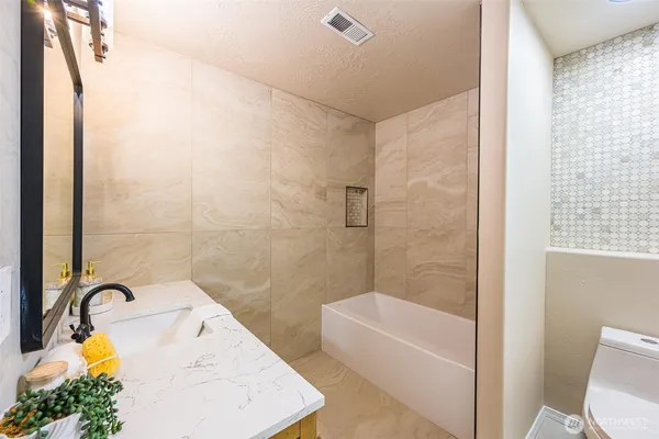 a bathroom with a tub and sink