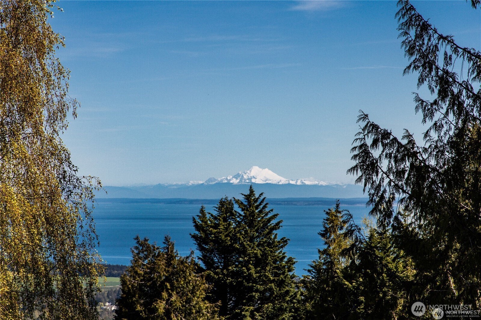 315 Quails Roost Road Sequim, WA 98382 - Photo 33 of 34 a view of a lake and a building