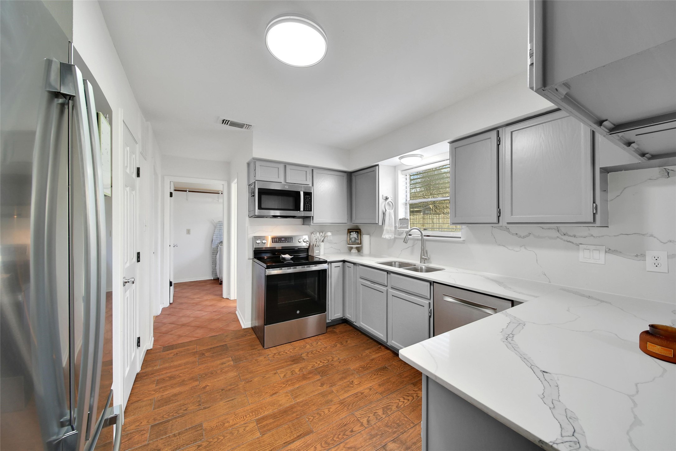 4206 Pineville Lane Spring, TX 77388 - Photo 13 of 35 a kitchen with stainless steel appliances granite countertop a sink stove and refrigerator