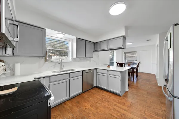 a kitchen with a sink stove and microwave