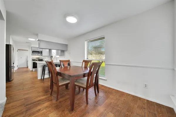 a view of a dining room with furniture and window