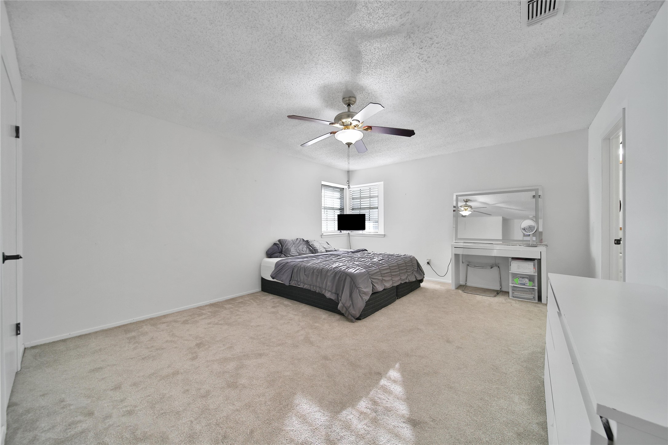 4206 Pineville Lane Spring, TX 77388 - Photo 22 of 35 a bedroom with a large bed and a chandelier