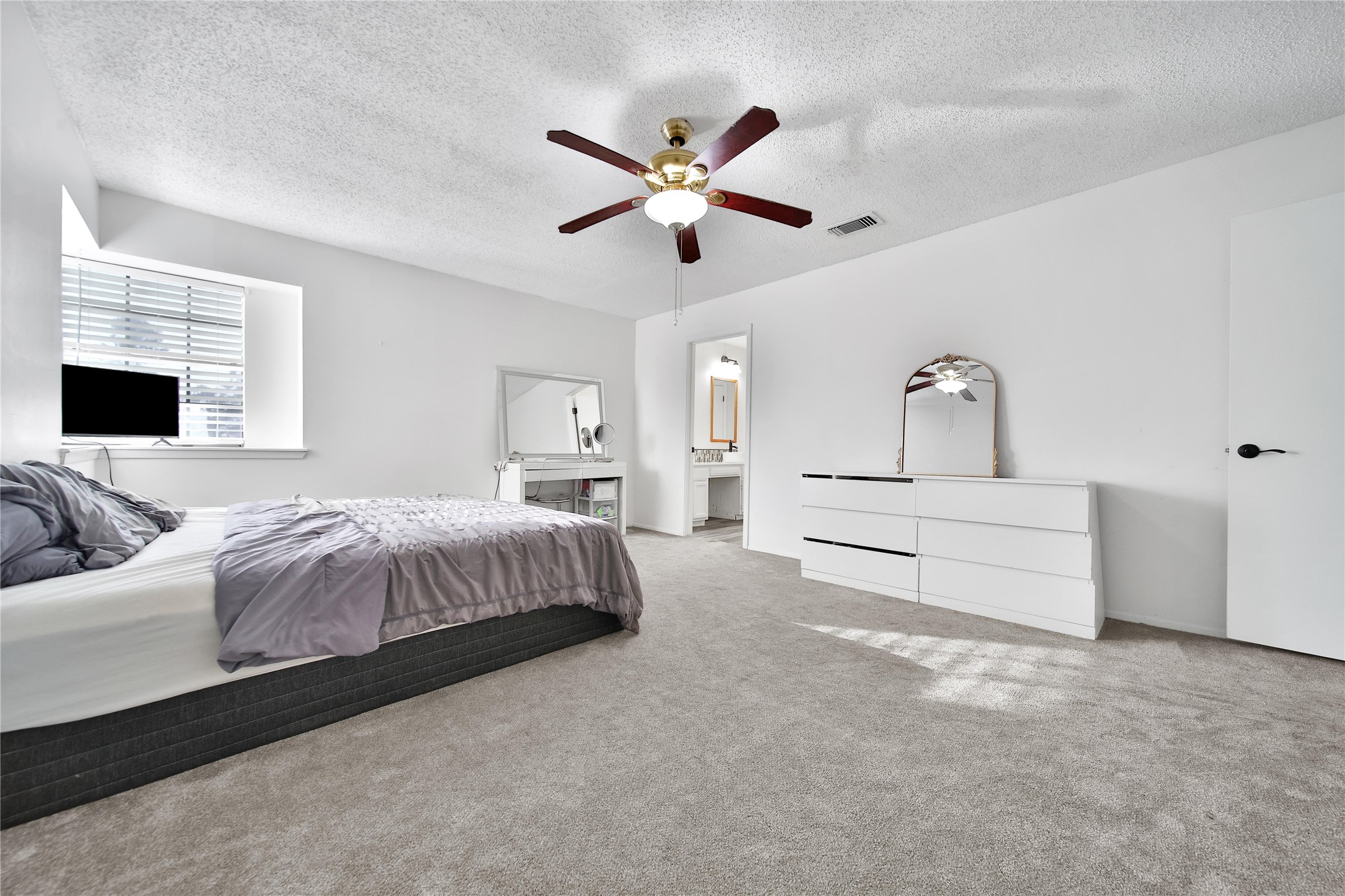 4206 Pineville Lane Spring, TX 77388 - Photo 23 of 35 a spacious bedroom with a large bed and ceiling fan