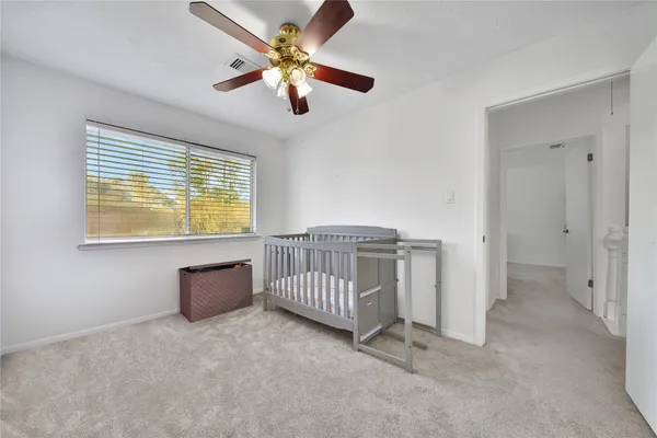 a view of room with window and ceiling fan