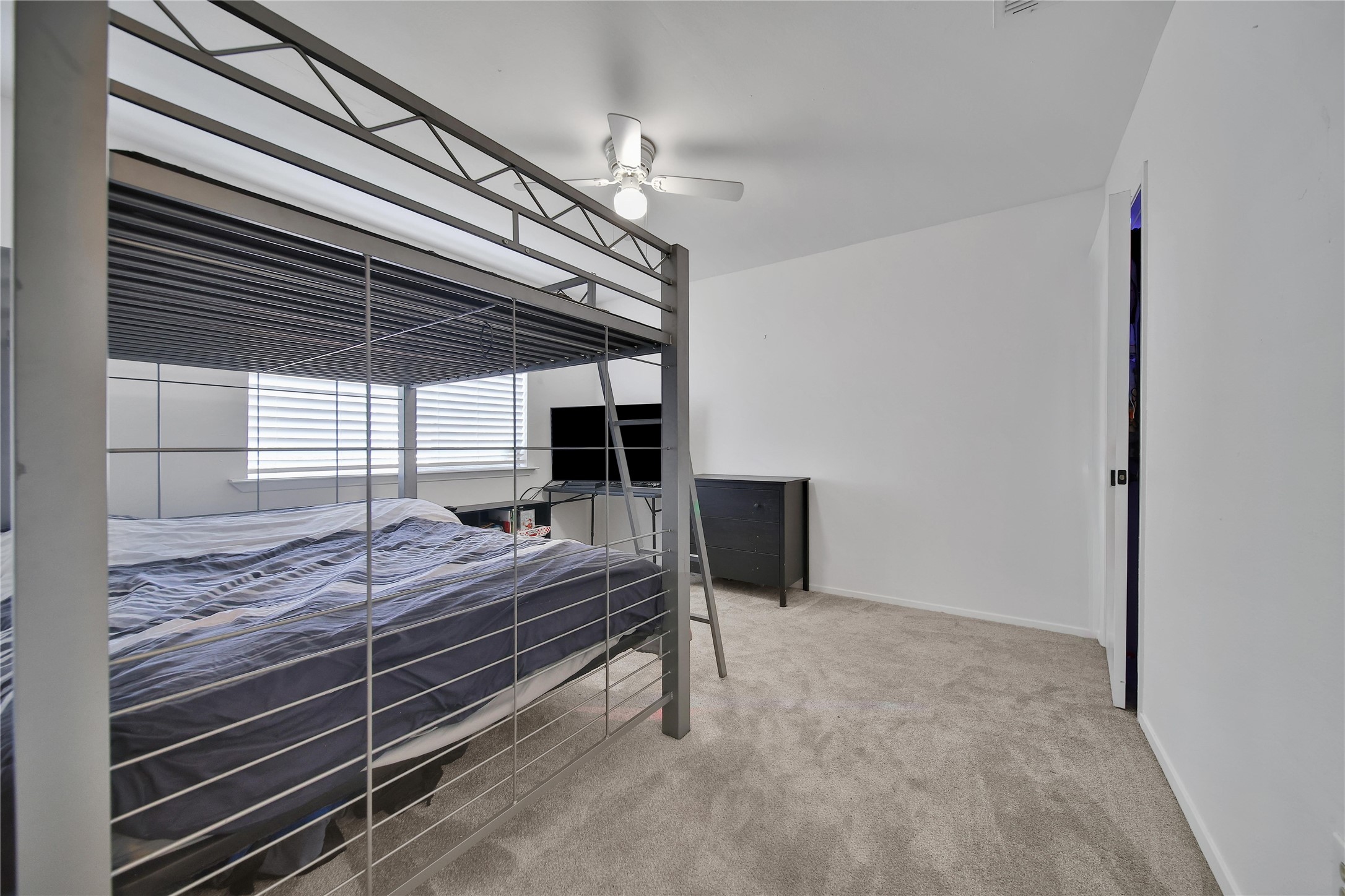 4206 Pineville Lane Spring, TX 77388 - Photo 30 of 35 a room with a bed and a ceiling fan