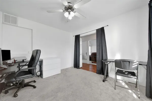 a living room with furniture a flat screen tv and a large window