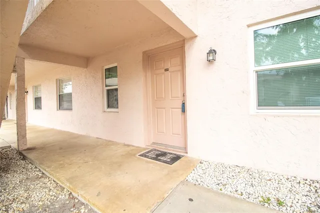 a view of a bedroom with wooden floor and a window