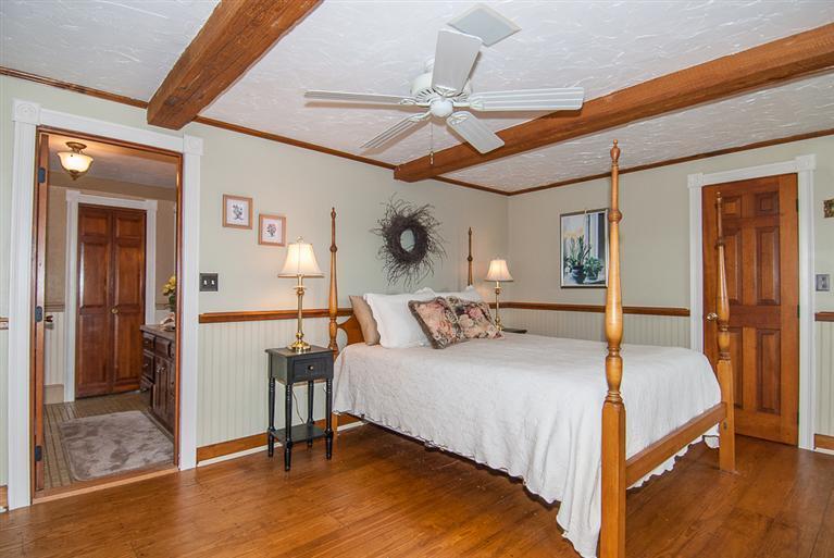 127 Point Hill Road West Barnstable, MA 02668 - Photo 19 of 29 a bedroom with a bed and a chandelier