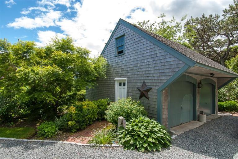 127 Point Hill Road West Barnstable, MA 02668 - Photo 2 of 29 a house with a flower garden in front of it