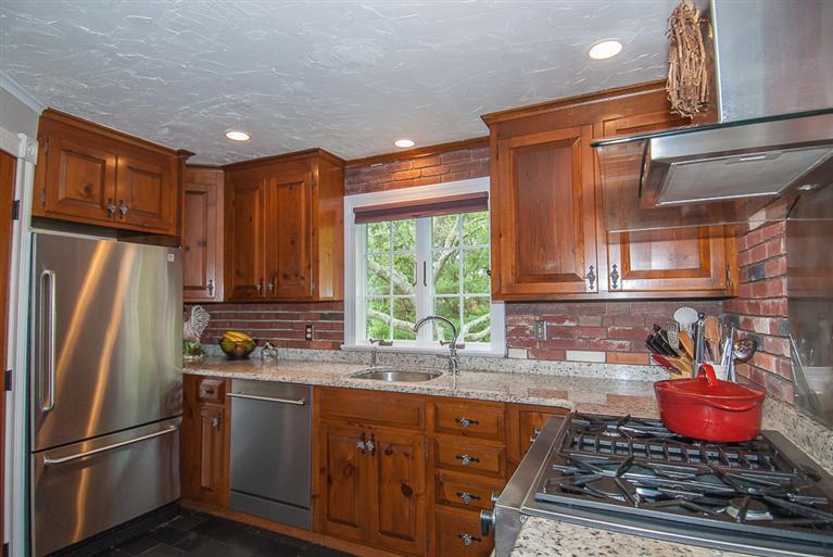 127 Point Hill Road West Barnstable, MA 02668 - Photo 9 of 29 a kitchen with stainless steel appliances granite countertop a refrigerator a sink a stove and a refrigerator