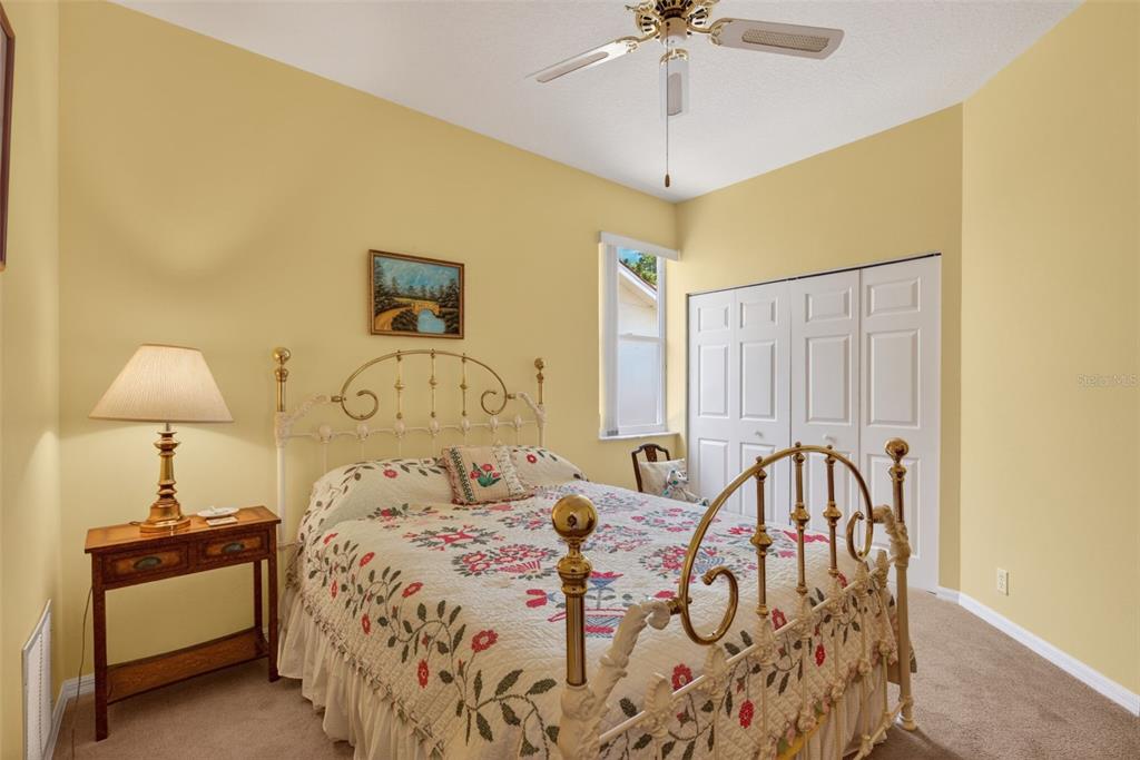 4266 Summertree Road Venice, FL 34293 - Photo 25 of 64 a bedroom with a bed and a chandelier