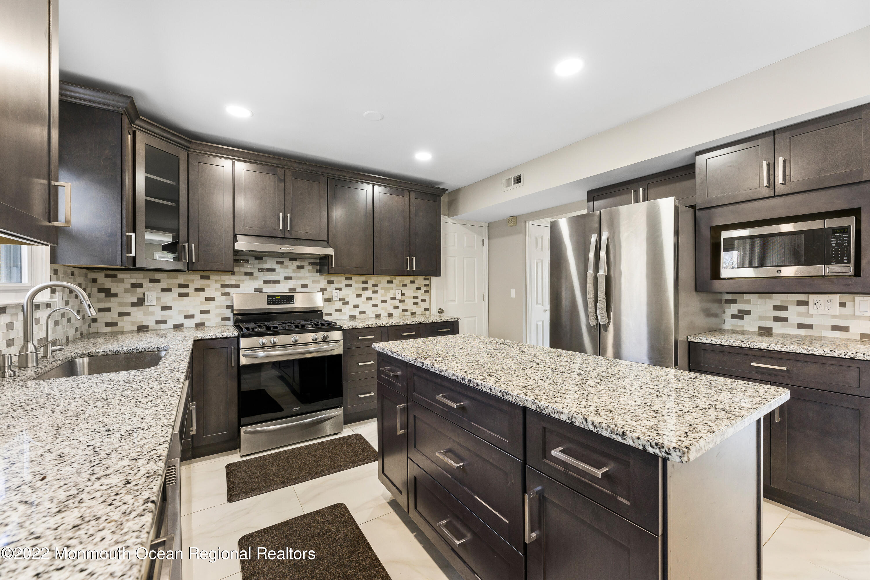10 Reed Road Howell, NJ 07731 - Photo 15 of 32 a kitchen with granite countertop stainless steel appliances and wooden cabinets