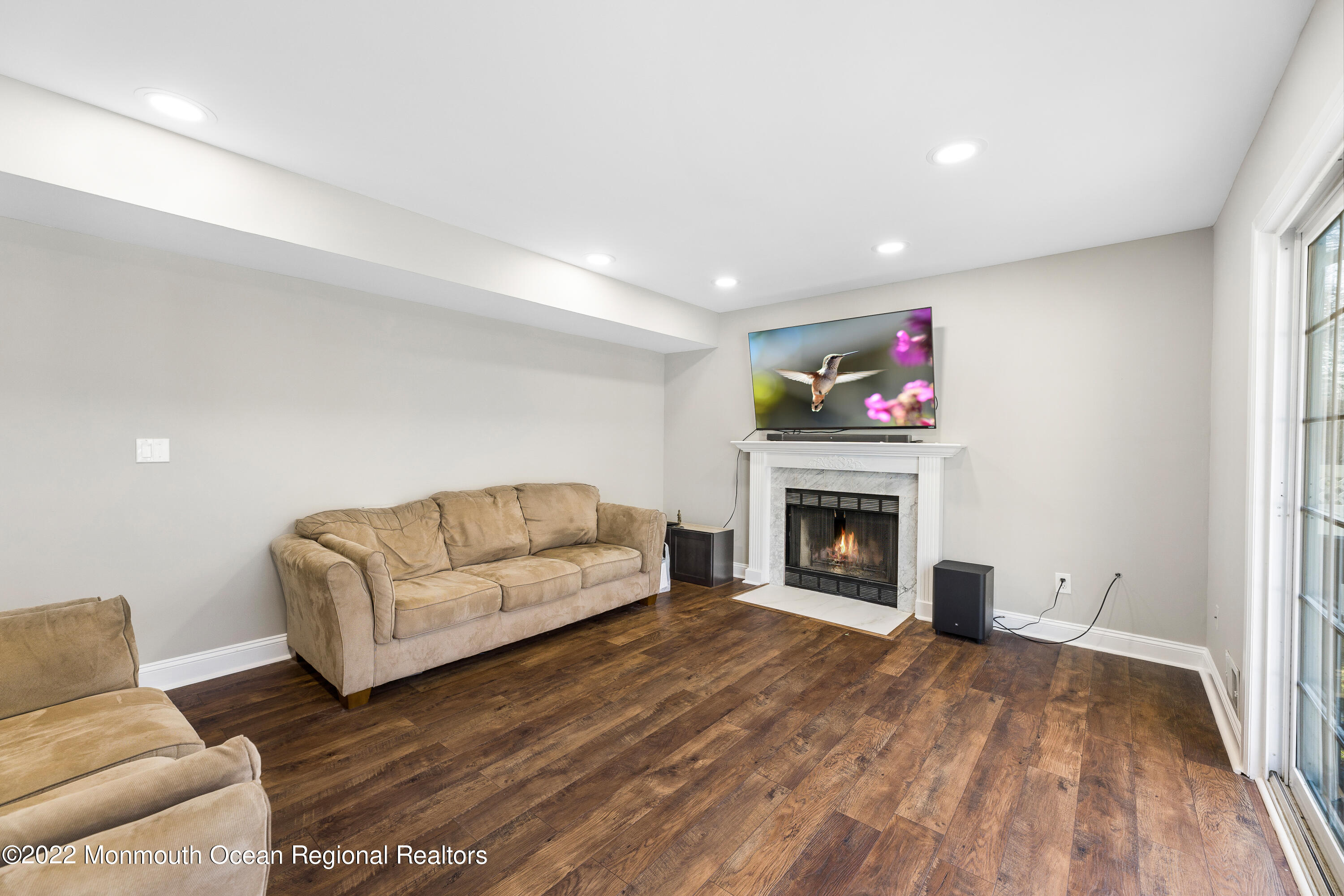 10 Reed Road Howell, NJ 07731 - Photo 18 of 32 a living room with furniture and a fireplace