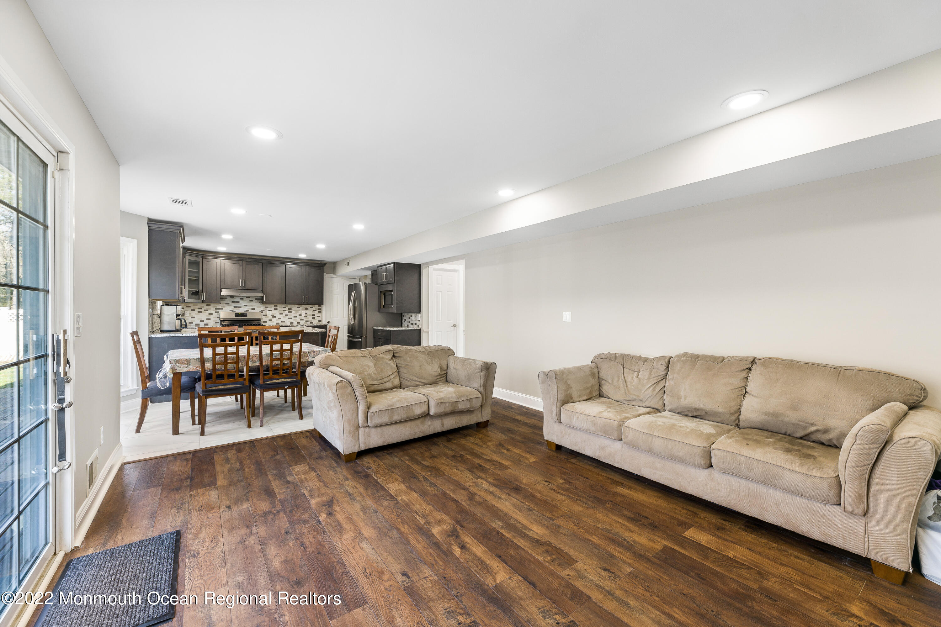 10 Reed Road Howell, NJ 07731 - Photo 19 of 32 a living room with furniture and kitchen view