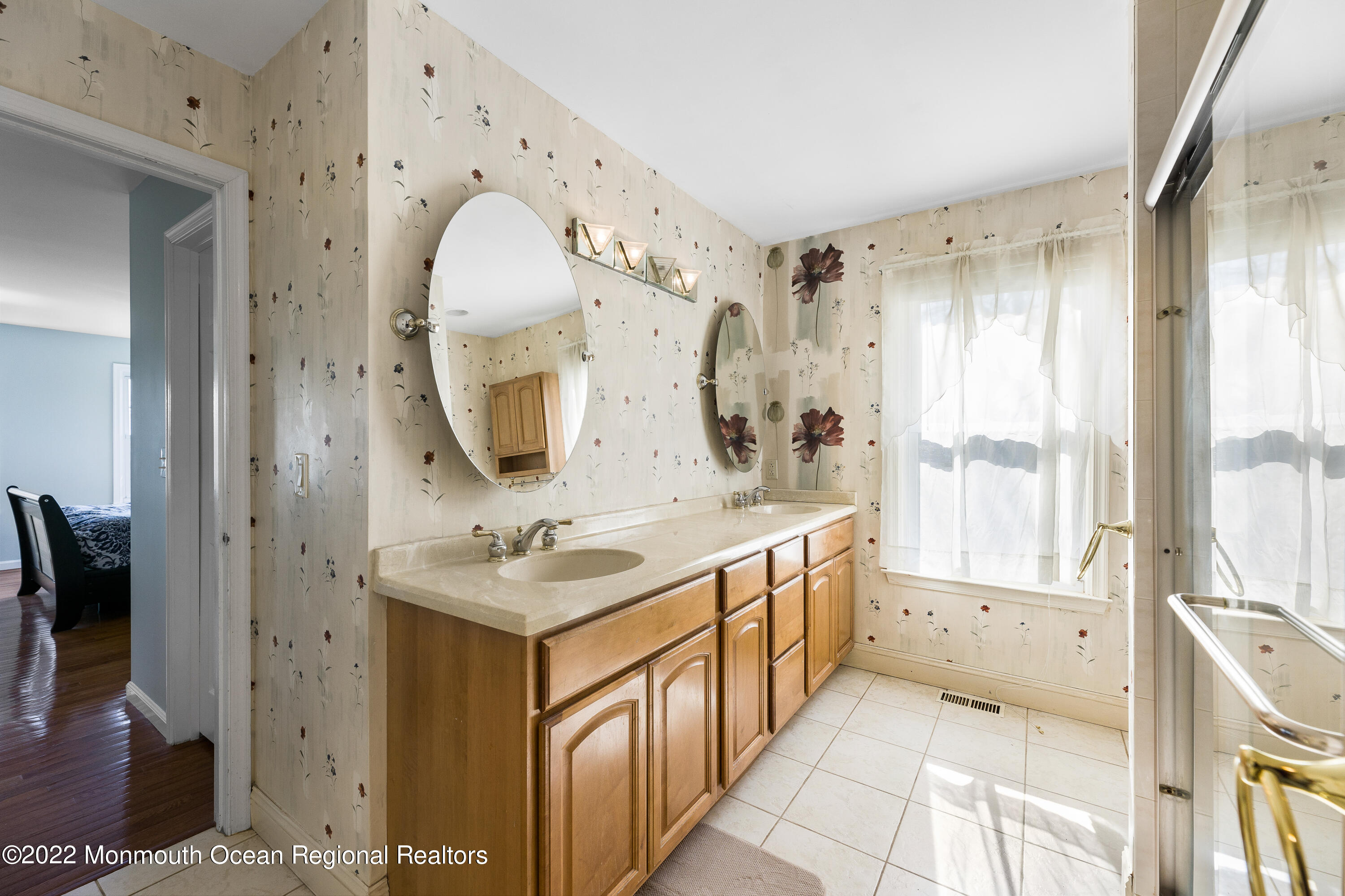 10 Reed Road Howell, NJ 07731 - Photo 23 of 32 a en suite bathroom with a double vanity sink and a mirror