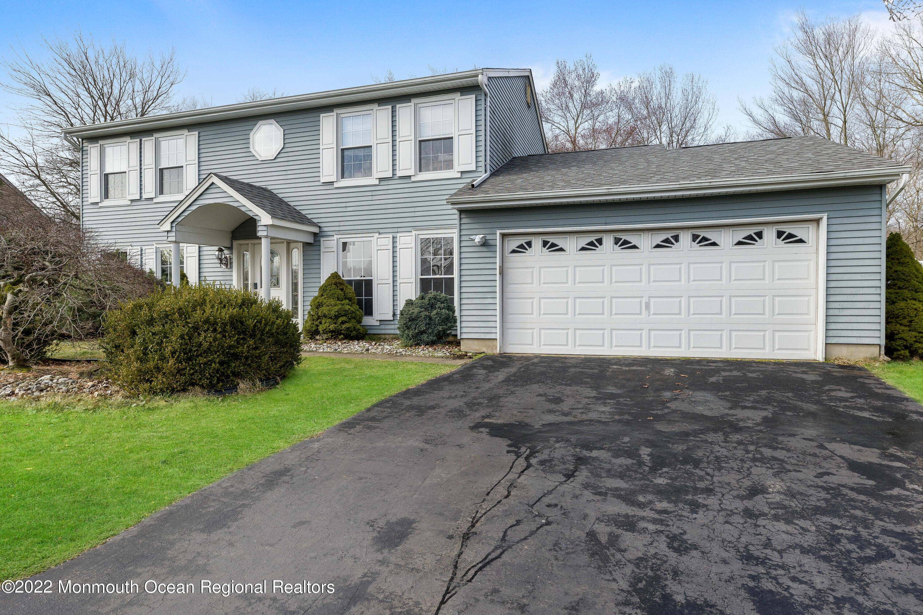 10 Reed Road Howell, NJ 07731 - Photo 3 of 32 a front view of a house with a yard and garage