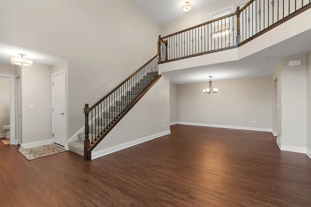 a view of staircase with wooden floor and a window