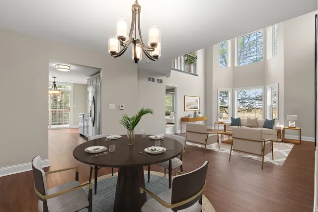 a view of a dining room with furniture wooden floor and chandelier
