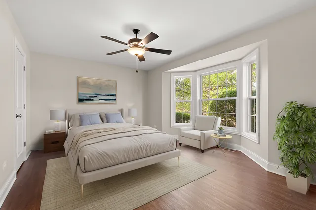 a spacious bedroom with a large bed and a chandelier