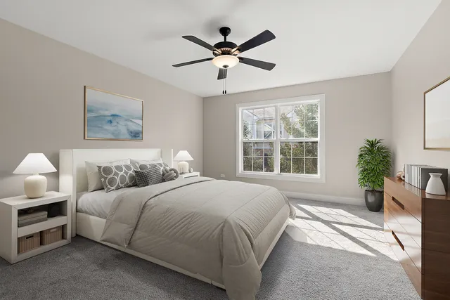 a bedroom with a large bed and a window