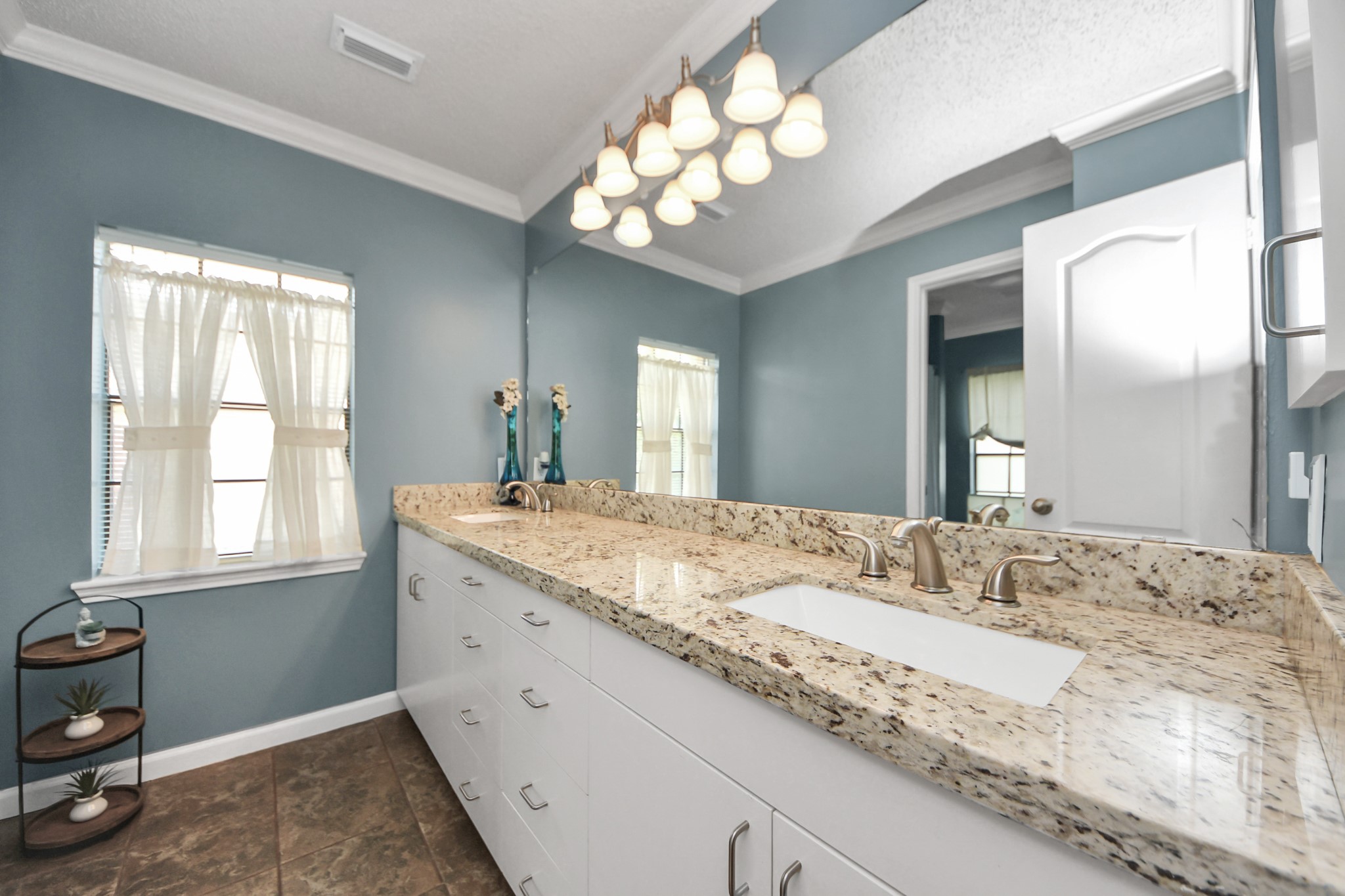 3107 Dulaney Road Houston, TX 77084 - Photo 23 of 50 a bathroom with a granite countertop sink a large mirror and vanity
