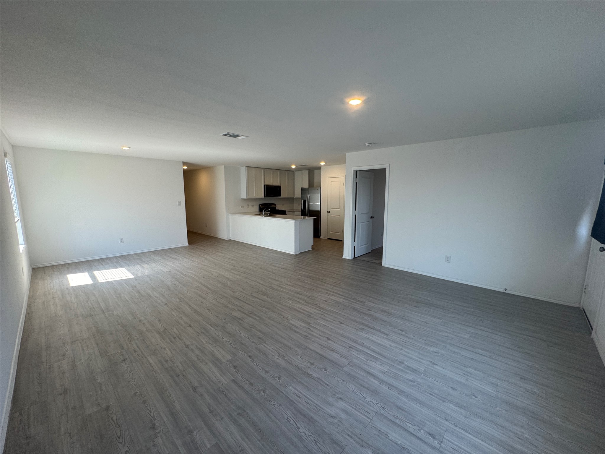 2218 Cumulus Court Lockhart, TX 78644 - Photo 7 of 35 a view of a big room with wooden floor and windows