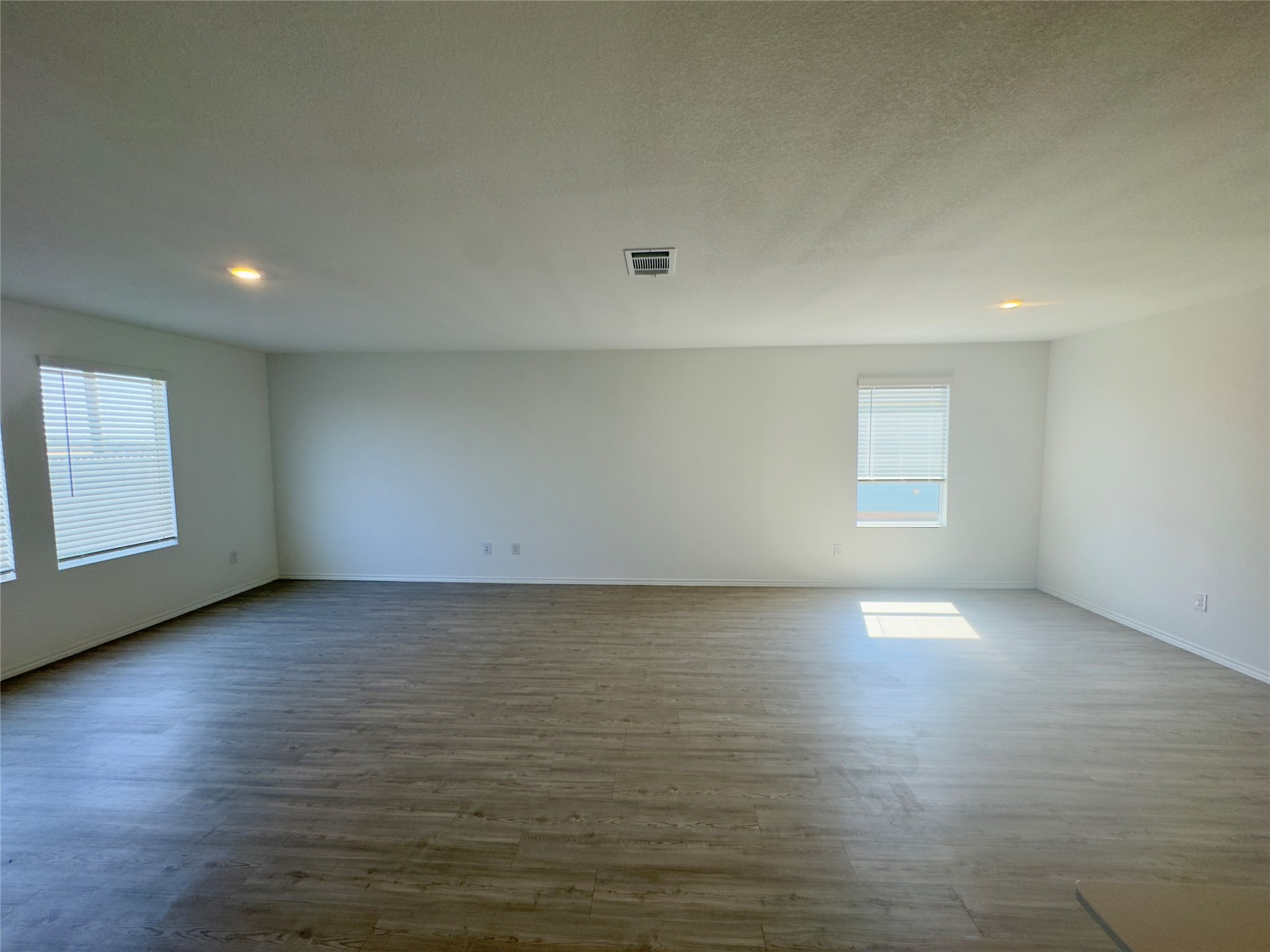 2218 Cumulus Court Lockhart, TX 78644 - Photo 9 of 35 wooden floor in an empty room with a window