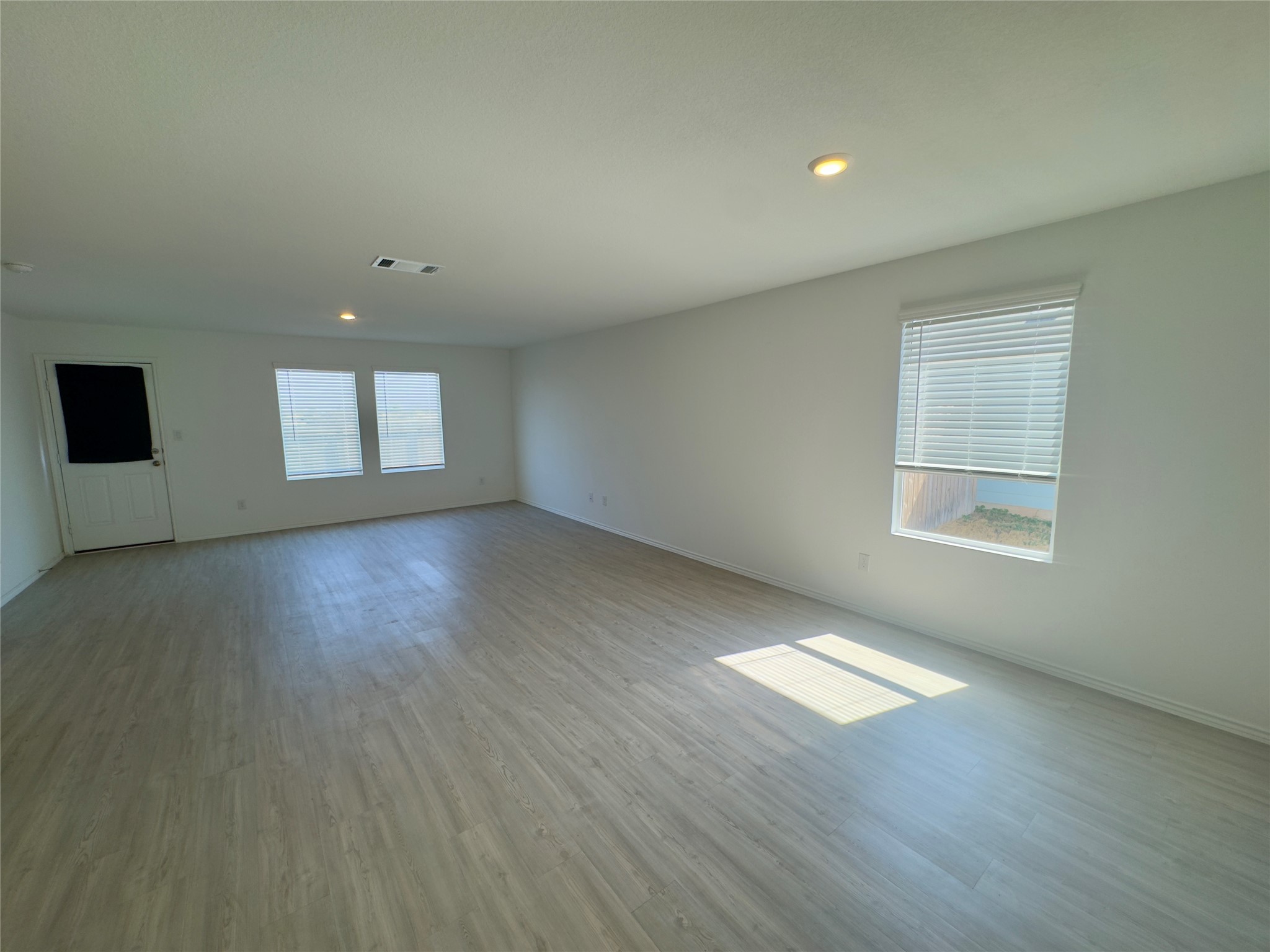 2218 Cumulus Court Lockhart, TX 78644 - Photo 10 of 35 an empty room with wooden floor and windows