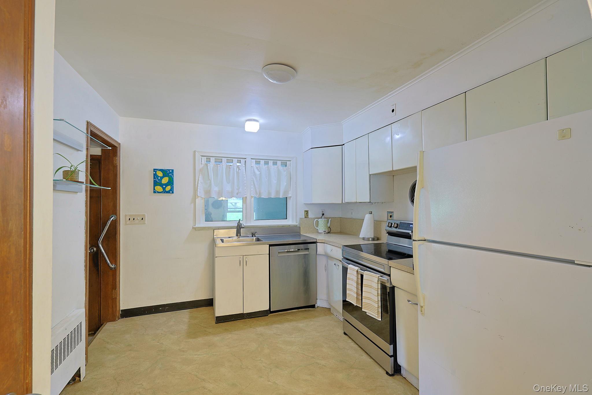 178 Mt Airy Road New Windsor, NY 12553 - Photo 8 of 31 a kitchen with a refrigerator a stove top oven a sink and cabinets