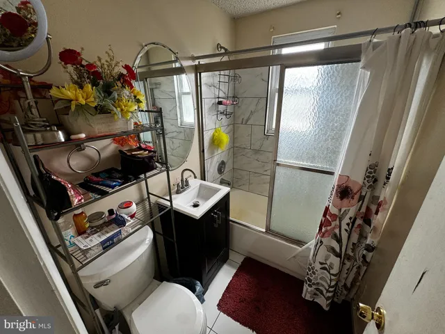 a bathroom with a sink mirror vanity and toilet