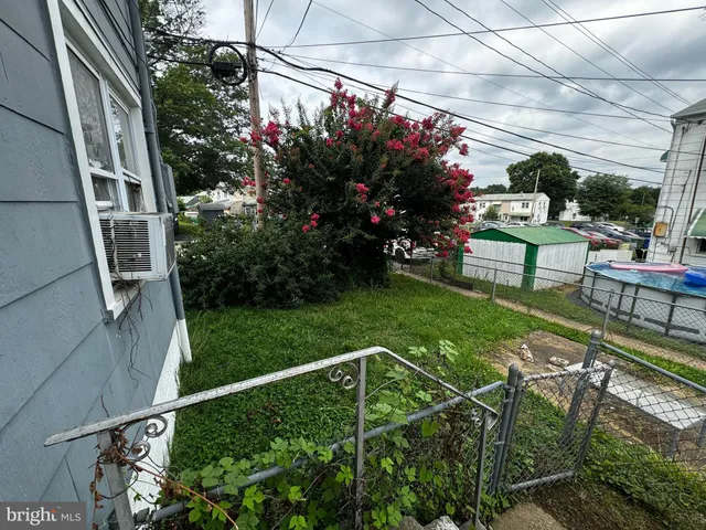 a view of a chair and tables in the backyard