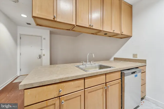 a kitchen with a sink and cabinets