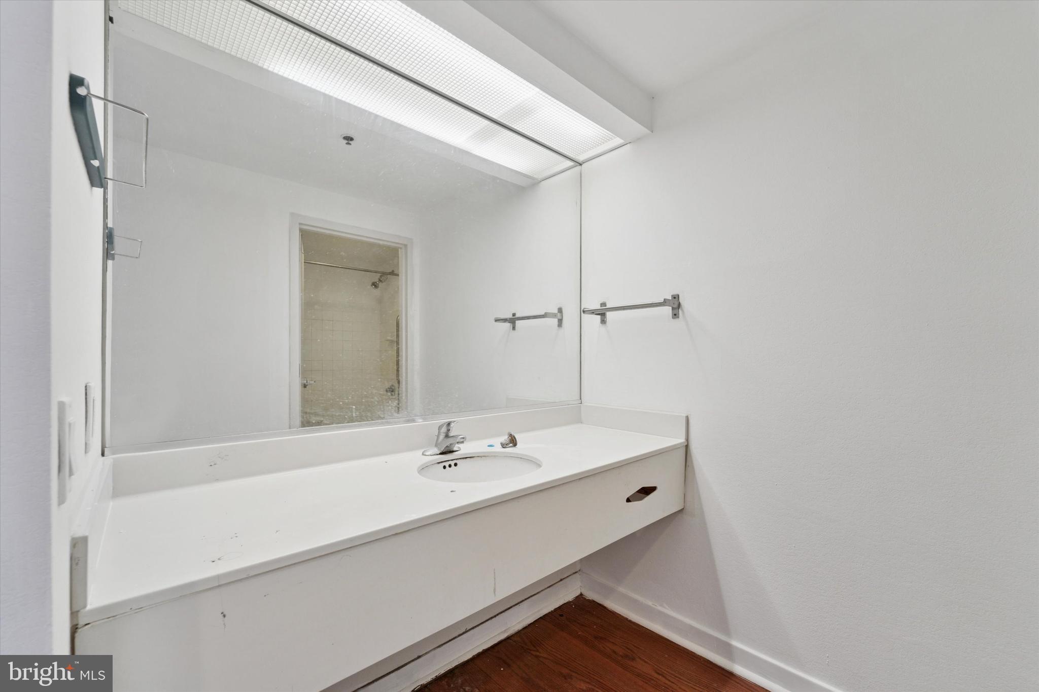 1100 Vine Street, Unit P211 Philadelphia, PA 19107 - Photo 14 of 20 a bathroom with a sink a mirror and a shower