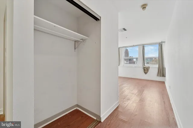 a view of a room with wooden floor