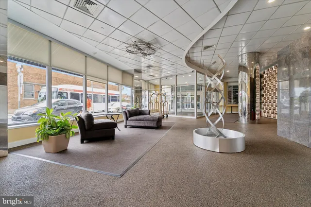 a lobby with furniture and floor to ceiling window