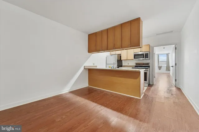 a kitchen with stainless steel appliances a refrigerator and a stove top oven