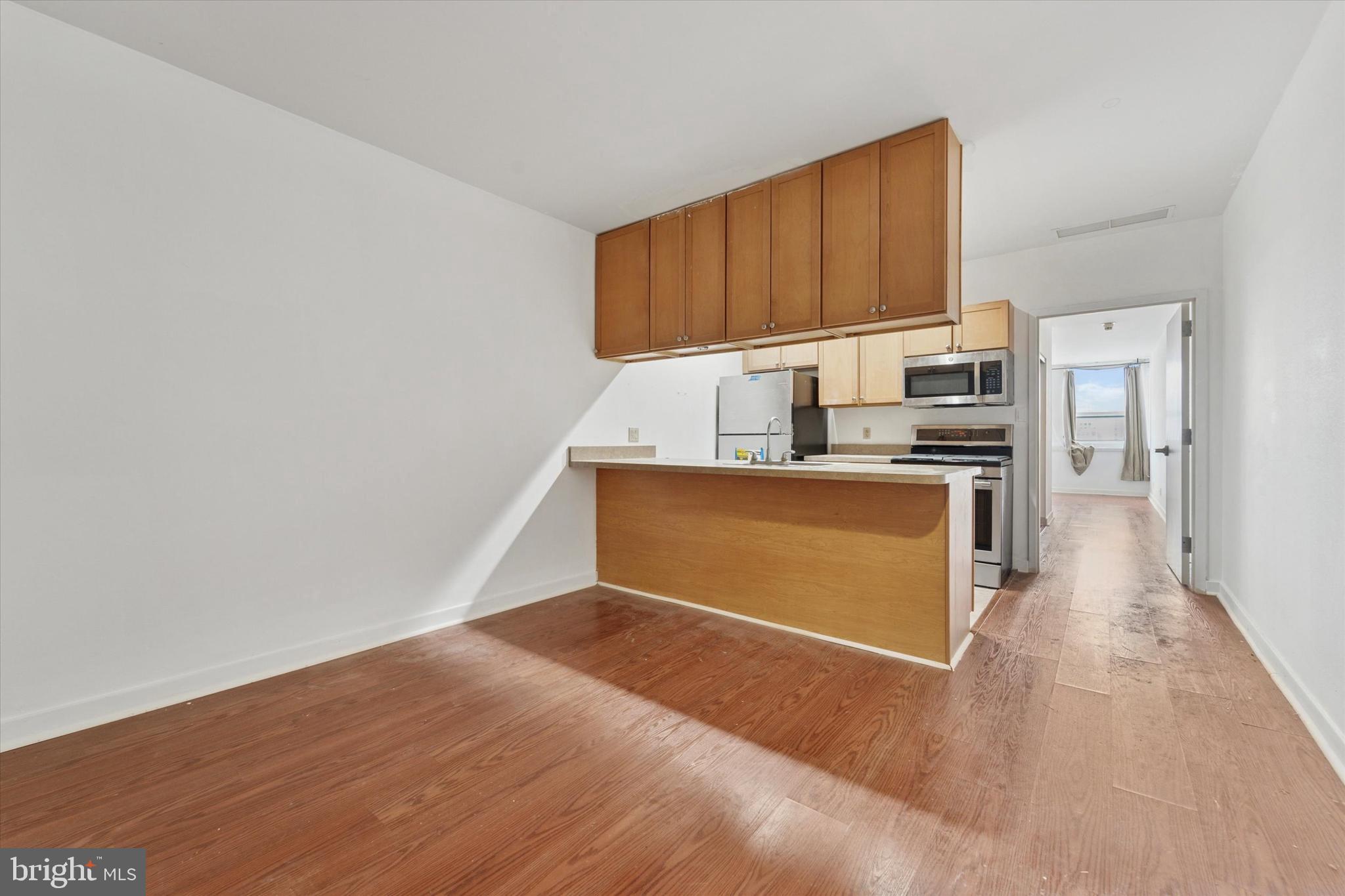1100 Vine Street, Unit P211 Philadelphia, PA 19107 - Photo 7 of 20 a kitchen with stainless steel appliances a refrigerator and a stove top oven