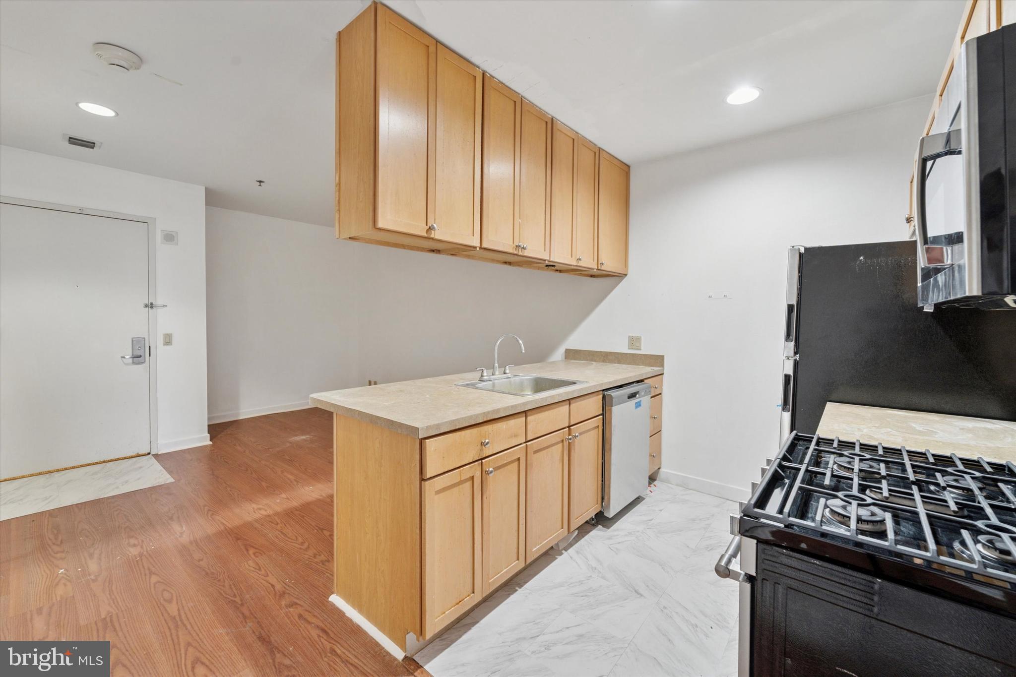 1100 Vine Street, Unit P211 Philadelphia, PA 19107 - Photo 10 of 20 a kitchen with a stove and a refrigerator