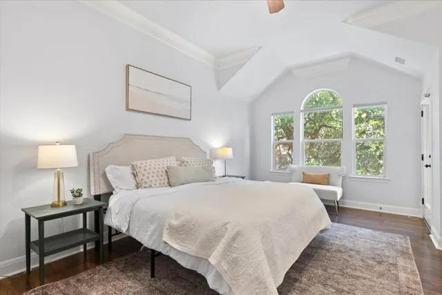 a bedroom with a bed and a large window