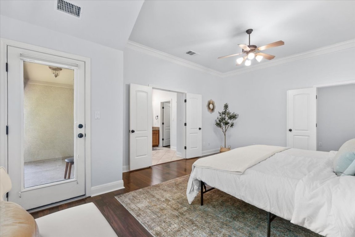15317 Origins Lane, Unit 203 Austin, TX 78734 - Photo 17 of 31 a bedroom with a bed and a chandelier