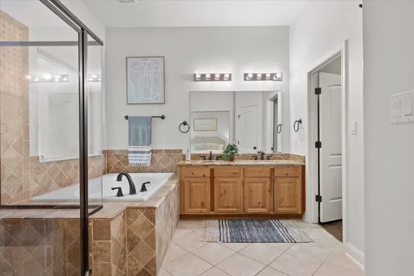 a large bathroom with a tub sink and mirror