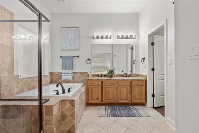 a bathroom with a tub sink and mirror