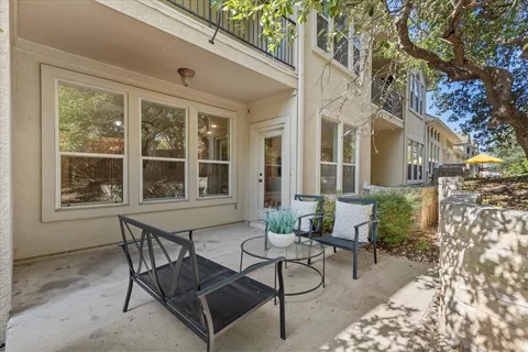 a view of a patio with table and chairs and potted plants