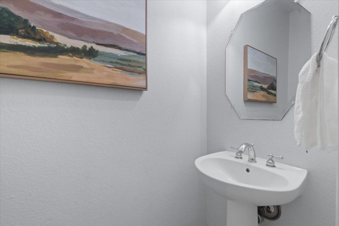 15317 Origins Lane, Unit 203 Austin, TX 78734 - Photo 26 of 31 a bathroom with a sink and a mirror